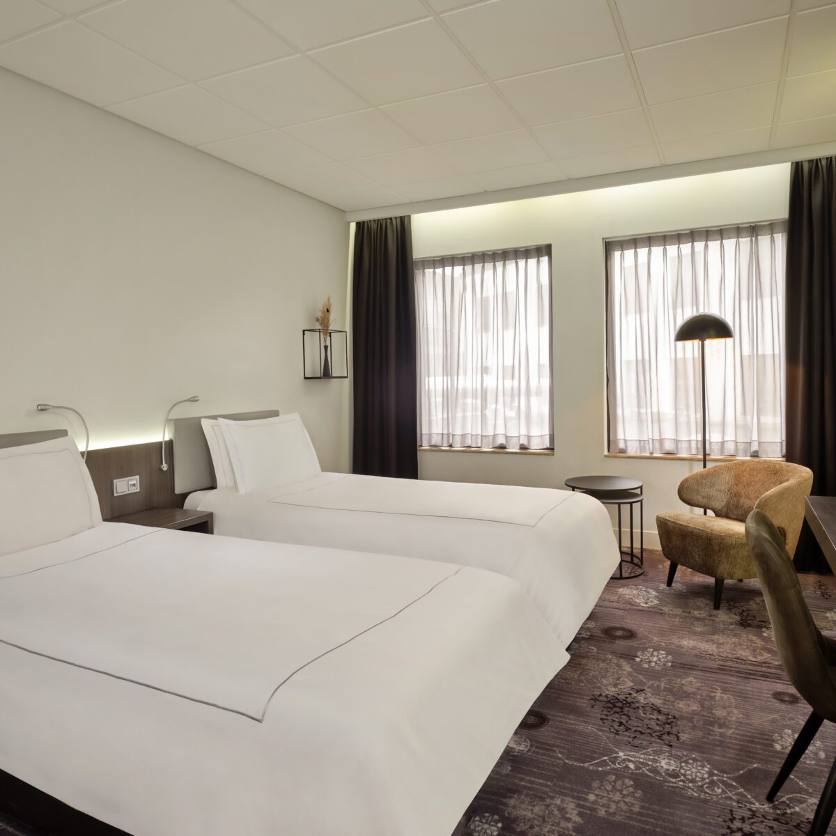 Park Plaza Eindhoven superior twin room with beds, window view, lounge chair, desk and TV